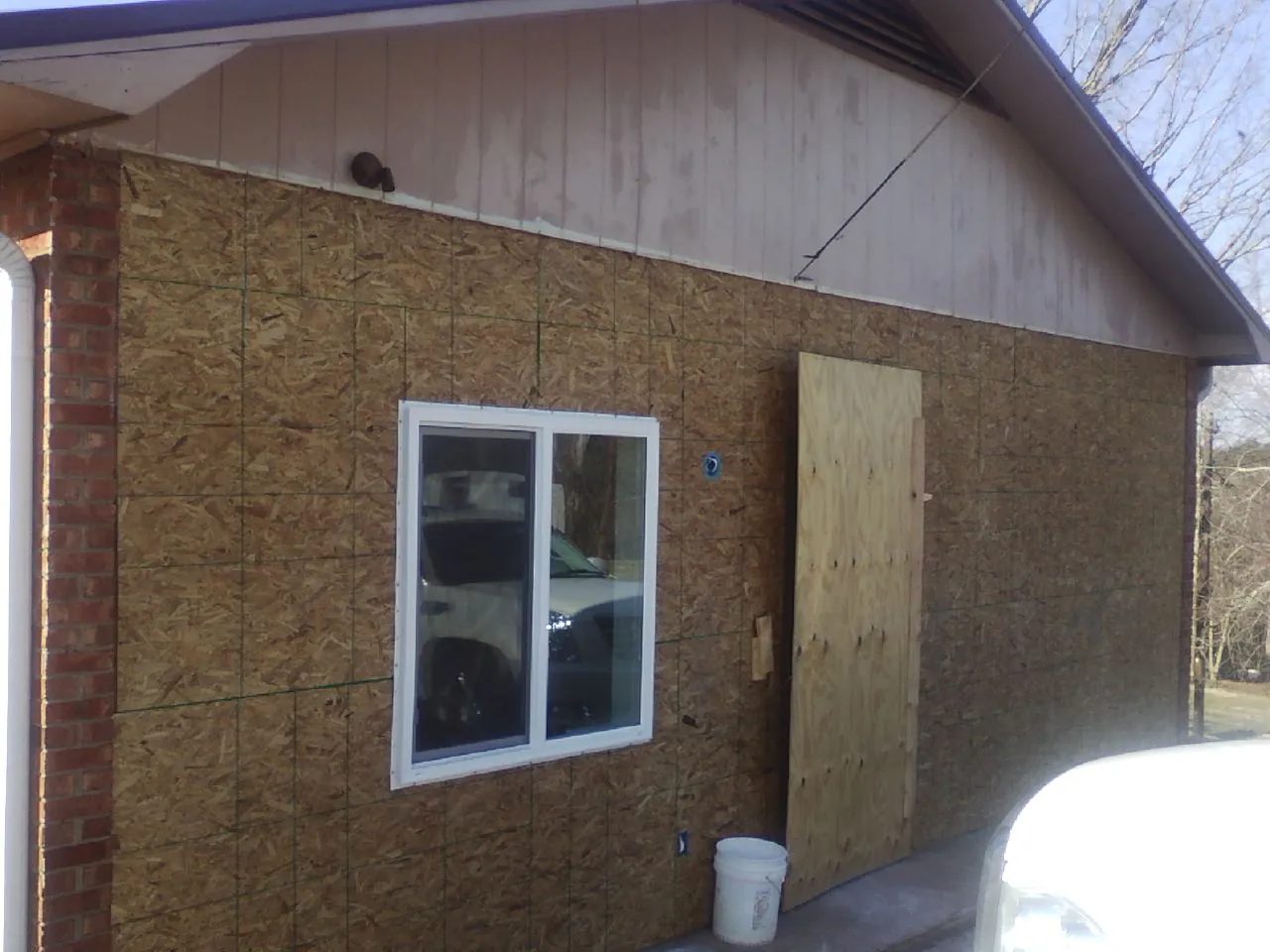 OSB sheathing on a garage addition wall before siding in Cypress
